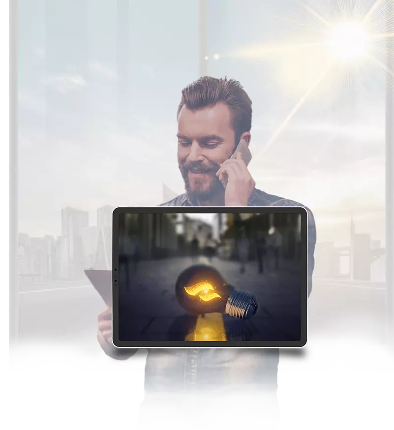 Business owner smiling while looking at his tablet